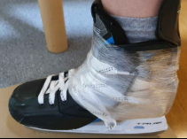 Hockey skate wrapped with stretch film during post-bake molding