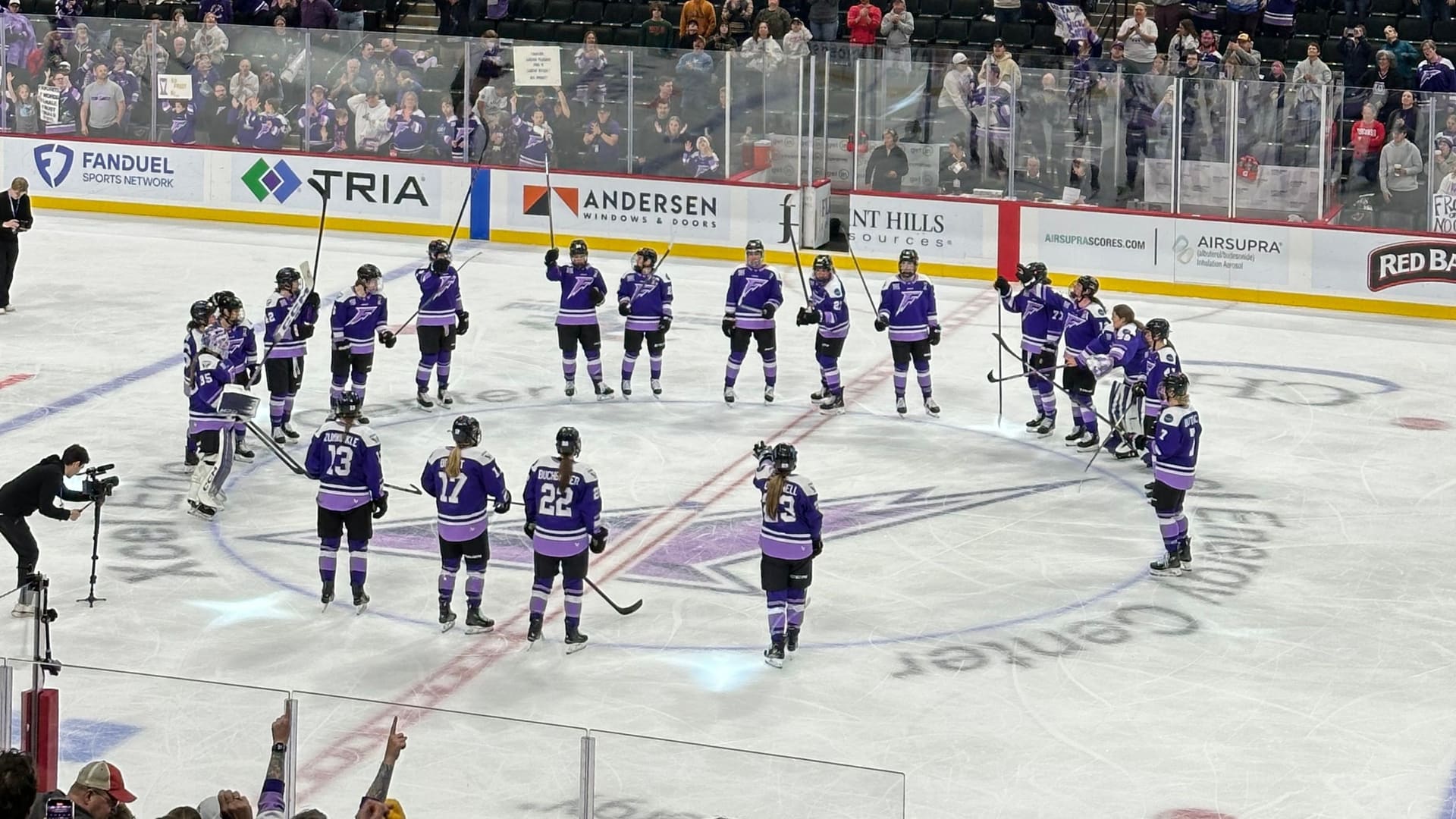 Women's hockey players skating through a game sequence after a whistle