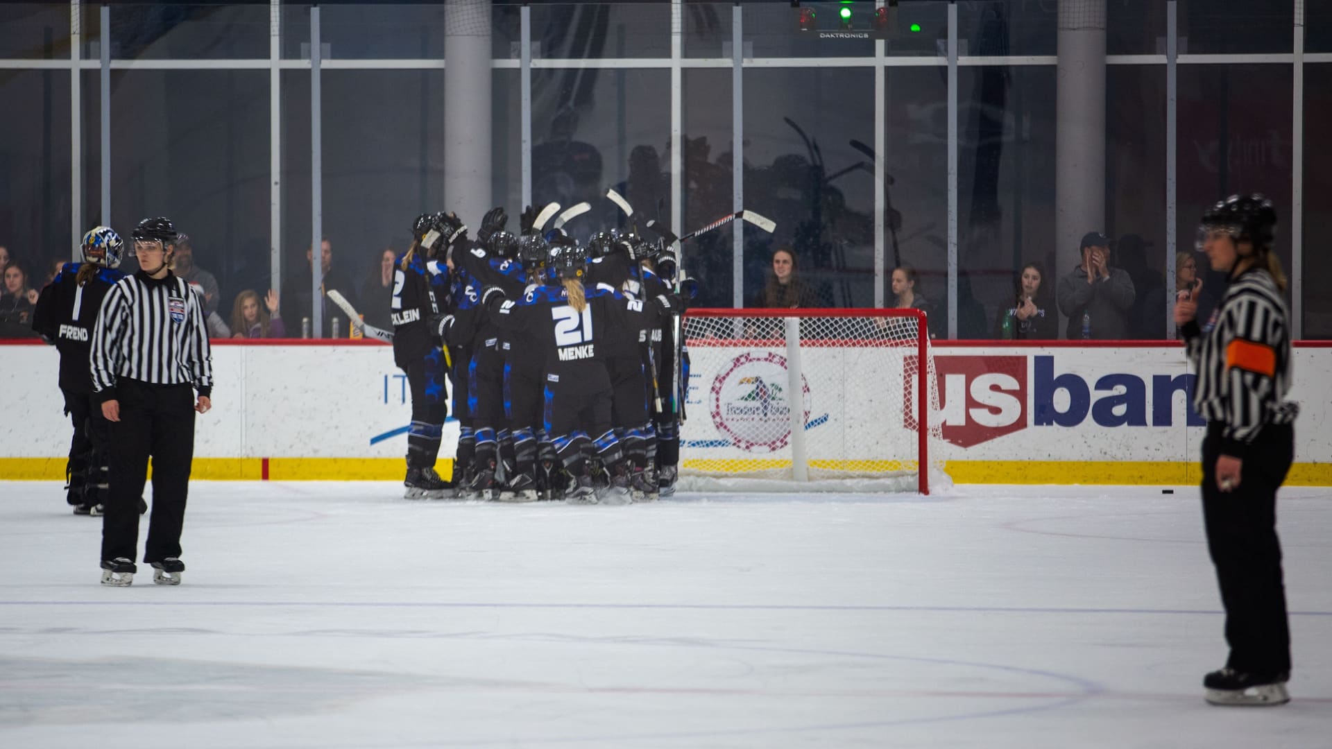 Women's hockey players lining up before a faceoff